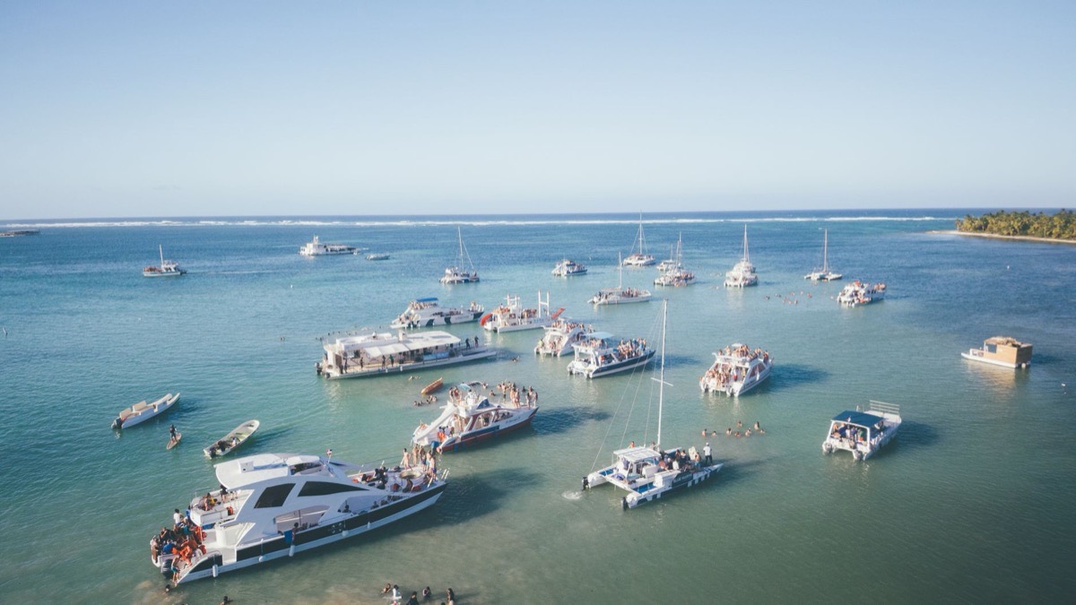 Catamaranes fondeados en aguas turquesas, vistos desde el aire