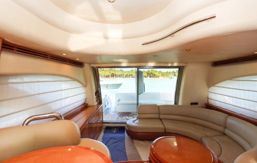 A yacht saloon with sofas opening onto the deck
