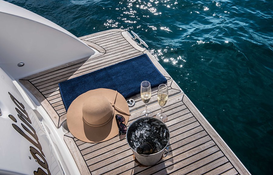 A sun hat, glasses and champagne on ice on the stern platform