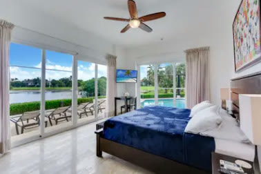 A bedroom with a window onto the lake